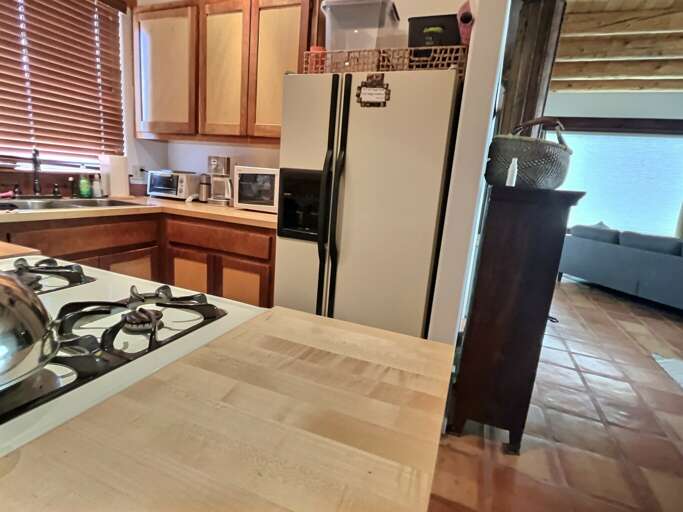 A small full kitchen with everything you need to cook and serve meals