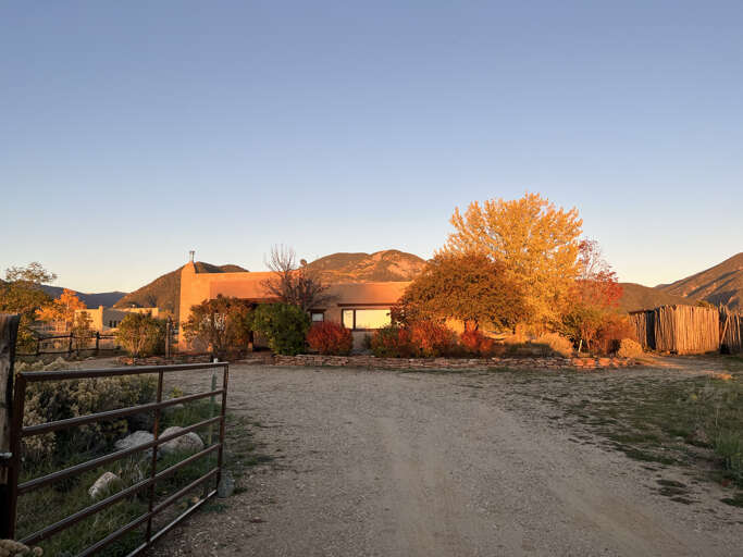 The view from the driveway entry, with sunset making the front of the home glow