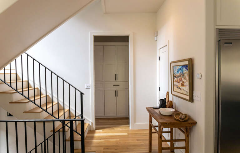 Stairs from ground level to living level to sleeping level and the living level sideboard.