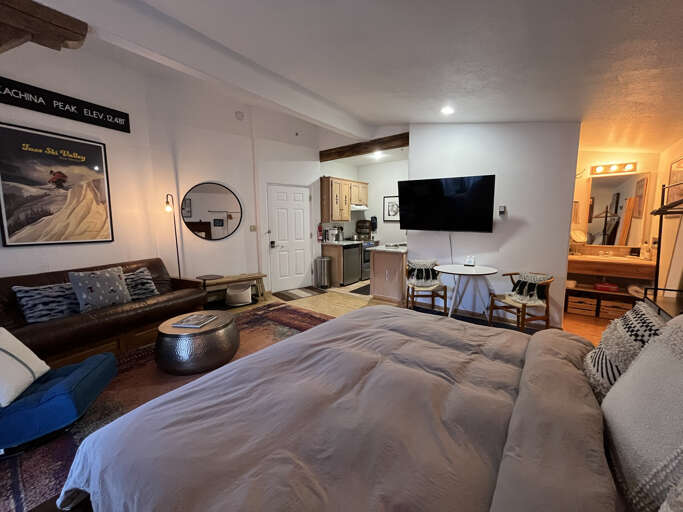 View from bed to living, dining, kitchen and bath areas