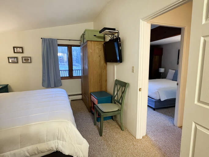 King bedroom storage and view into hallway to queen bedroom