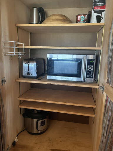 Tucked away microwave and toaster in the pantry