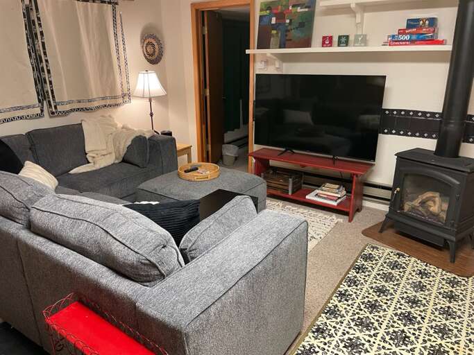 Front room with gas fireplace and smart TV