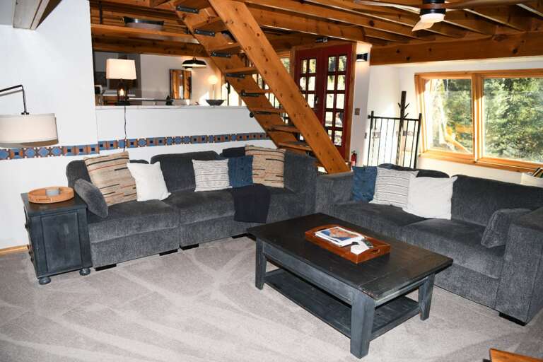 Living area with stairs going to master bedroom