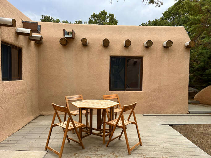 House wraps around this central patio where you can also dine