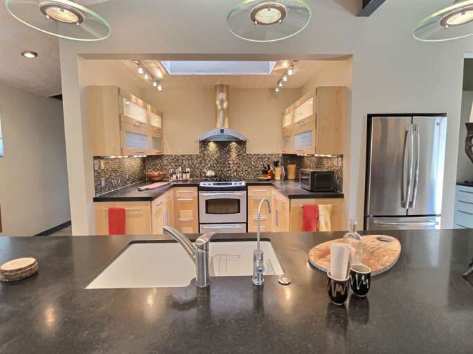 The gourmet kitchen with thoughtful lighting, top quality everything from fixtures and appliances to kitchen tools and dining ware