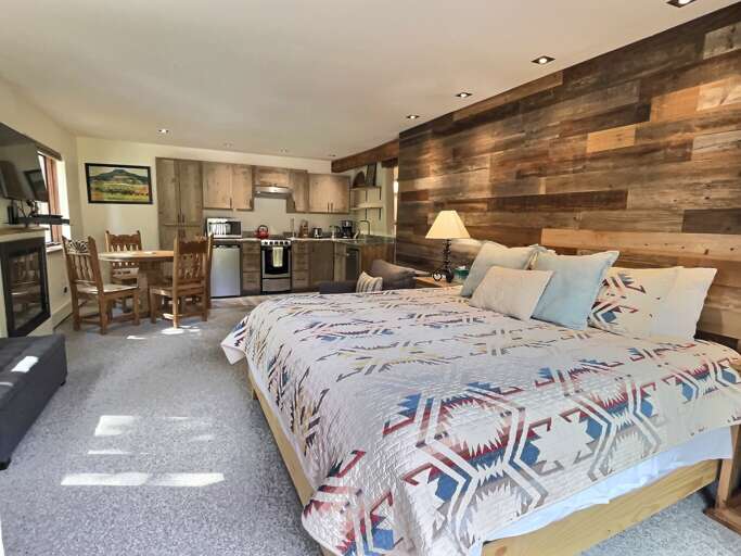 The studio bedroom blends into the living area and main kitchen