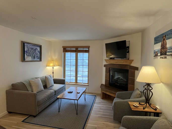 Flat screen smart TV and sitting area from the kitchen