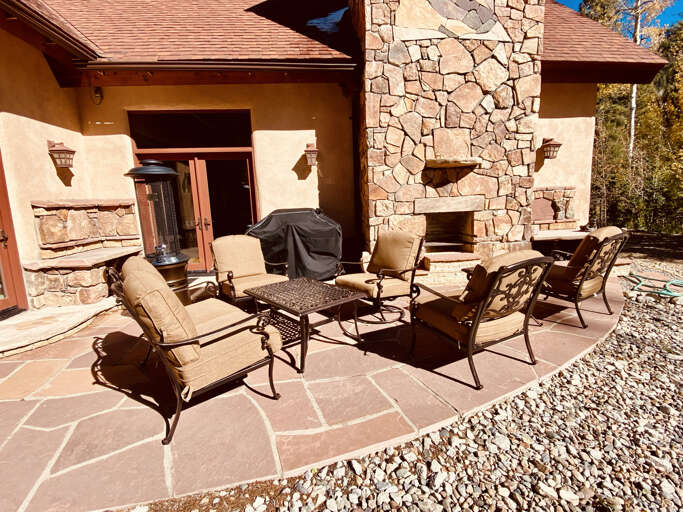 Patio with fireplace and grill in summer