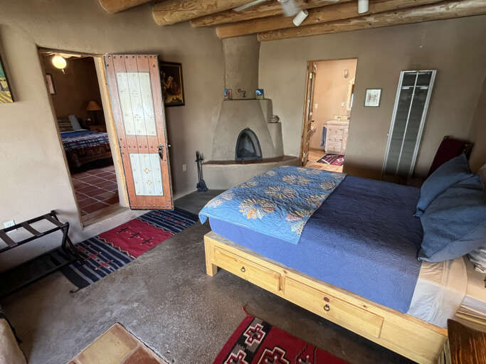 Traditional adobe floors in primary bedroom