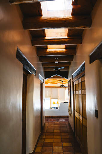 Exposed wooden beams and warm terracotta floors guide you toward your bright, welcoming kitchen space.