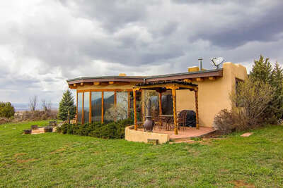 Home South and East facing picture windows and grilling patio