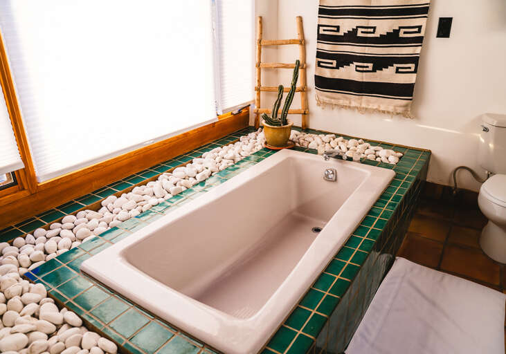 Soak in your private tiled spa tub surrounded by smooth river stones and southwestern charm for ultimate relaxation.