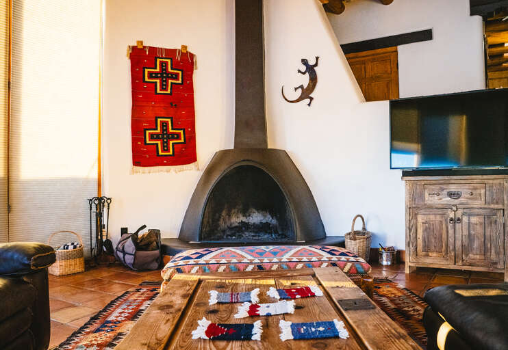 Cozy up in your rustic Southwest-style living room, where handcrafted furnishings and a traditional kiva fireplace create the perfect gathering space.