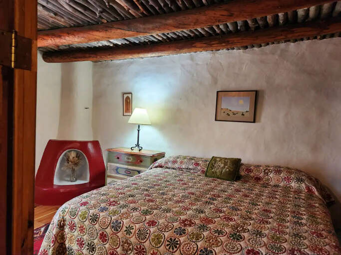 Bedroom with decorative kiva fireplace