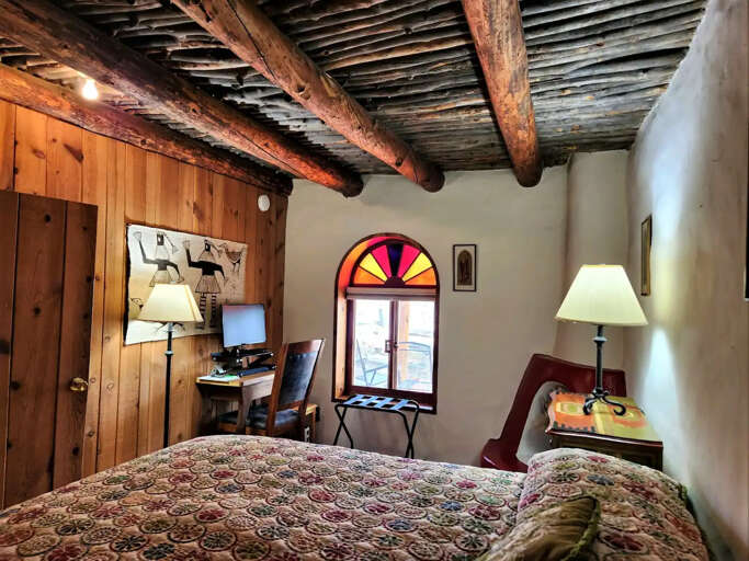 Vigas ceilings throughout the home and rainbow stained glass accent