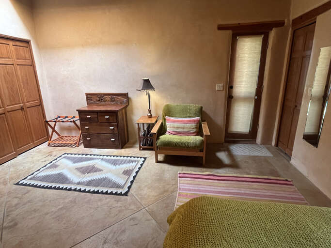 Queen bedroom sitting area and clothing storage