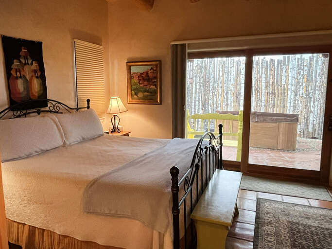 Primary King bedroom with easy sliding door access to private hot tub area