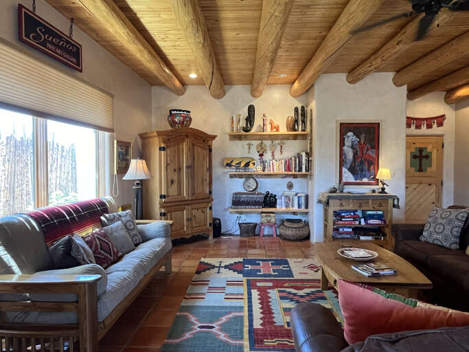 Relaxing livingroom space with high viga (wood beam) and latilla ceilings