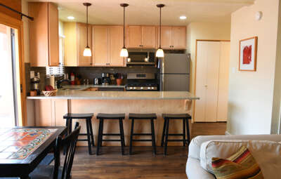 Kitchen bar seating, stone counter tops and modern appliances