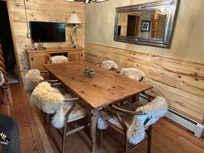 Formal dining table with shearling seat covers
