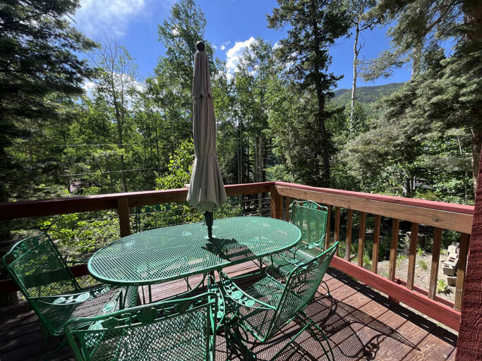 Outdoor metal dining set with umbrella on the big front deck