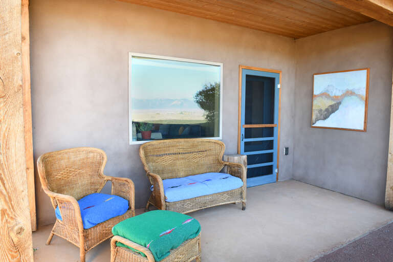 Back porch sitting area with art and garden views