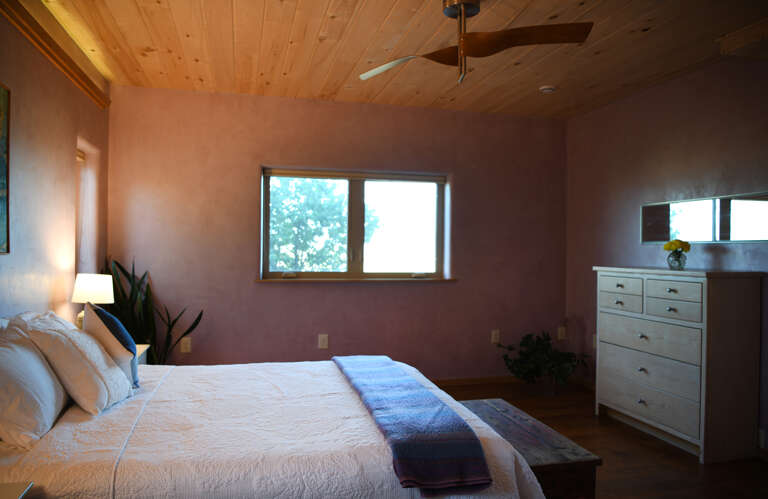Comfortable queen bedroom with ceiling fan