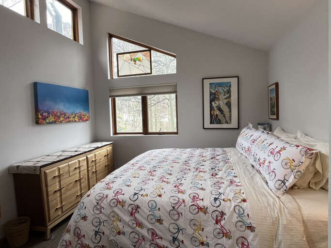 King suite bedroom with mountain views and clothing storage