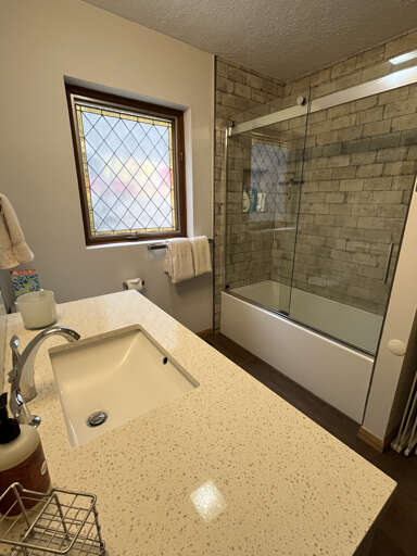 Vanity and tub/shower combo in downstairs bathroom