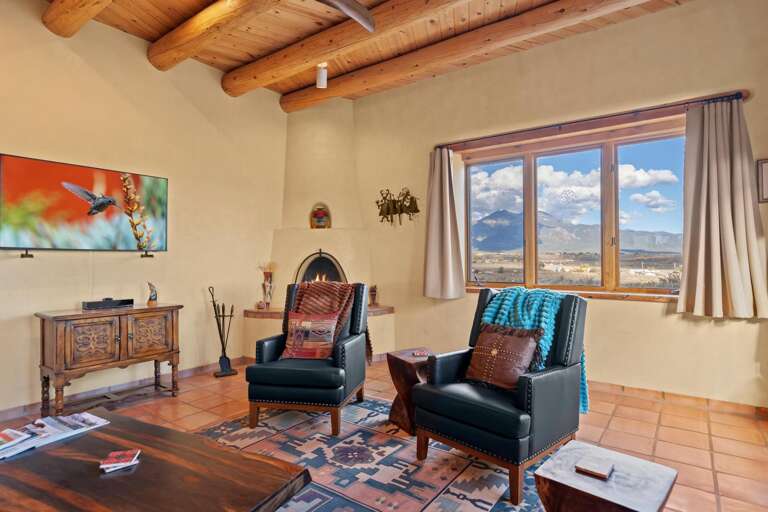 Sitting area in living toom with TV and kiva fireplace
