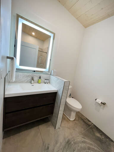 Bunk bedroom bathroom with single vanity and shower tub combo