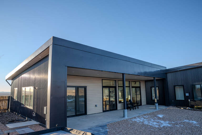 Modern architectural design featuring sleek lines and contemporary materials under clear blue skies.