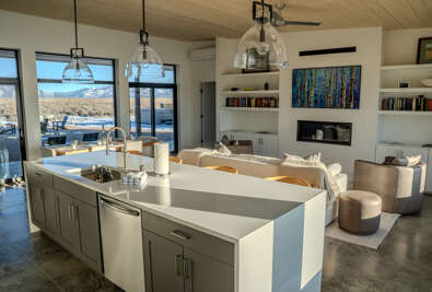 You'll love cooking in this stunning modern kitchen while enjoying breathtaking mountain views through floor-to-ceiling windows.