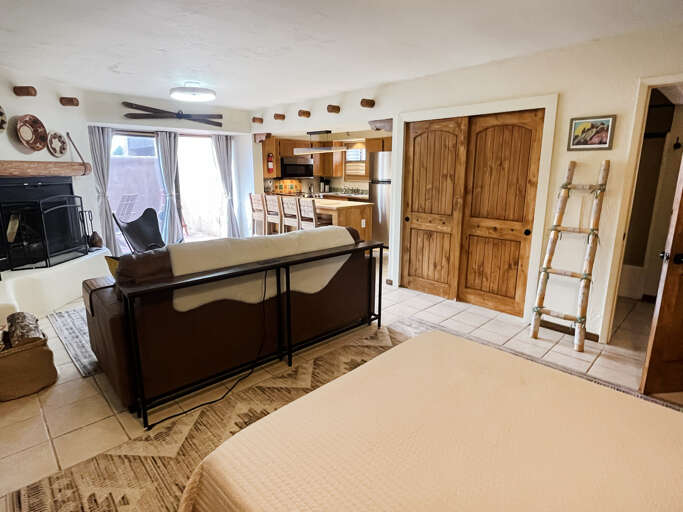 Living area from the sleeping space, bed can be stowed to make more usable space for work or play