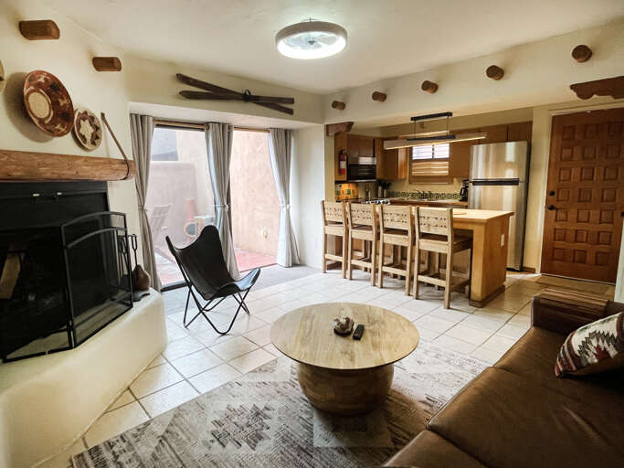 Sliding doors to private patio and livingroom area with view of kitchen