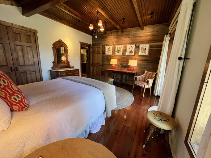 Primary main level queen bedroom with antique furnishings