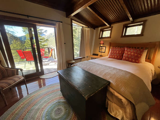 Primary main level queen bedroom with deck access