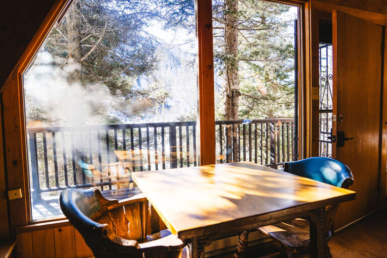 Cafe table catches warm sunlight in the front of the cabin