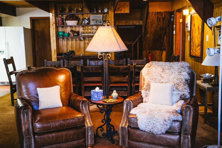 Comfortable leather arm chairs set up for cozy any time of day