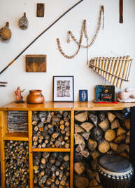 Cozy up in your charming retreat where handcrafted instruments and rustic decor create a warm, artistic atmosphere perfect for relaxing evenings.