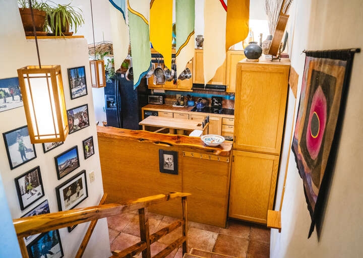 Discover your creative haven with warm wood furnishings, vibrant art, and a compact kitchen where you can craft meals.
