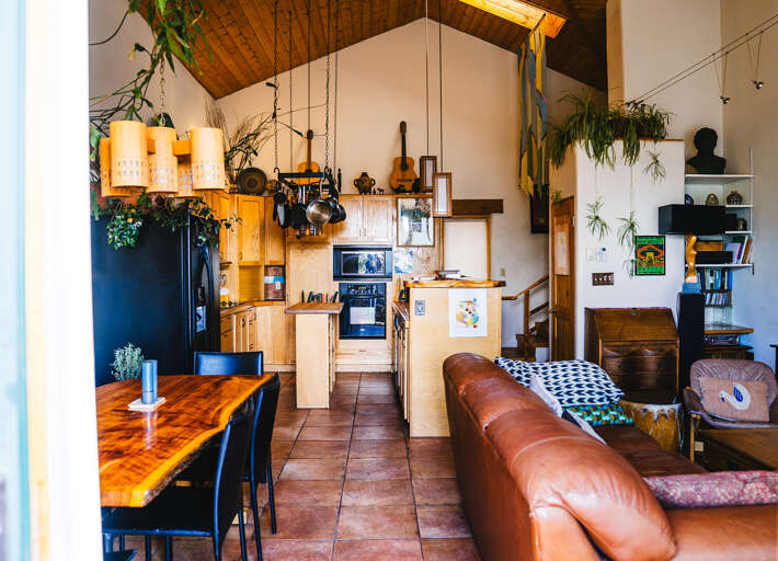 Sink into the rich leather sofa and take in this charming open-concept space where rustic wood meets modern comfort perfectly.