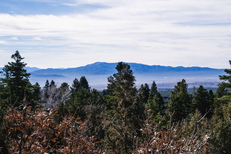 Stunning mountain vistas stretch across layered peaks and valleys, creating a breathtaking natural backdrop for the property's elevated location.