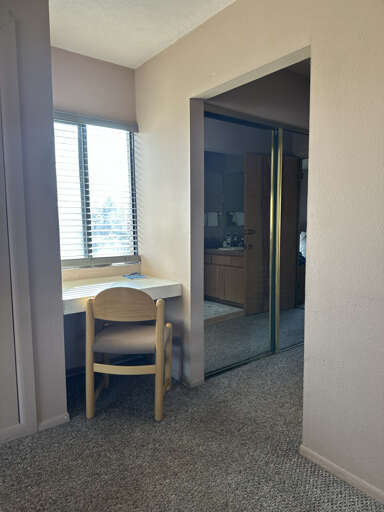 Your bright workspace by the window offers natural light for productivity, while your private bathroom awaits just steps away.