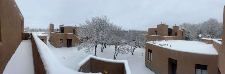 A fresh snow covers the courtyard below the condos