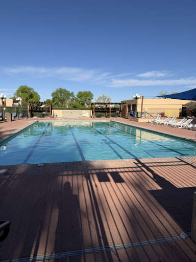 The outdoor pool beckons under clear blue skies, with lap lanes for morning swims and poolside loungers where you can soak up the sun.