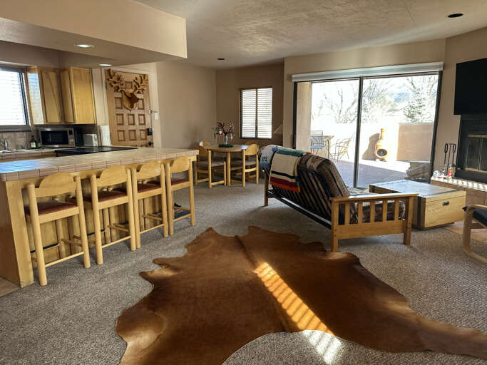 Relax in your cozy living space with rustic charm, where warm wood furniture meets Native American-inspired dÃ©cor and a crackling fireplace awaits.