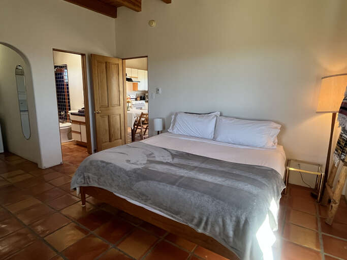 Rest peacefully in your charming bedroom with exposed wooden beams, terracotta floors, and crisp linens that invite deep, restful sleep.