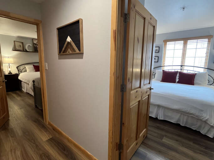 Two cozy bedrooms connected by hallway.